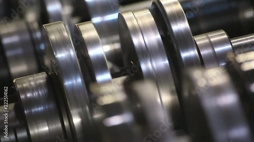Profiles are created on the metal rolling machine at the plant. creation of profiles, machine for creation of steel profiles from steel sheet. close-up