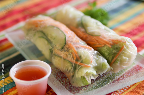 Asian vegetable rolls  in rice paper with spicy sauce for dipping photo