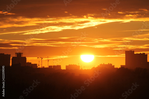 Cityscape with silhouette of city skyline against setting sun. Minsk, Belarus