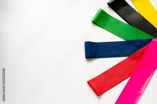 Free Download Fitness gum, elastic expanders of different colors isolated on white background.  - GFXLoad