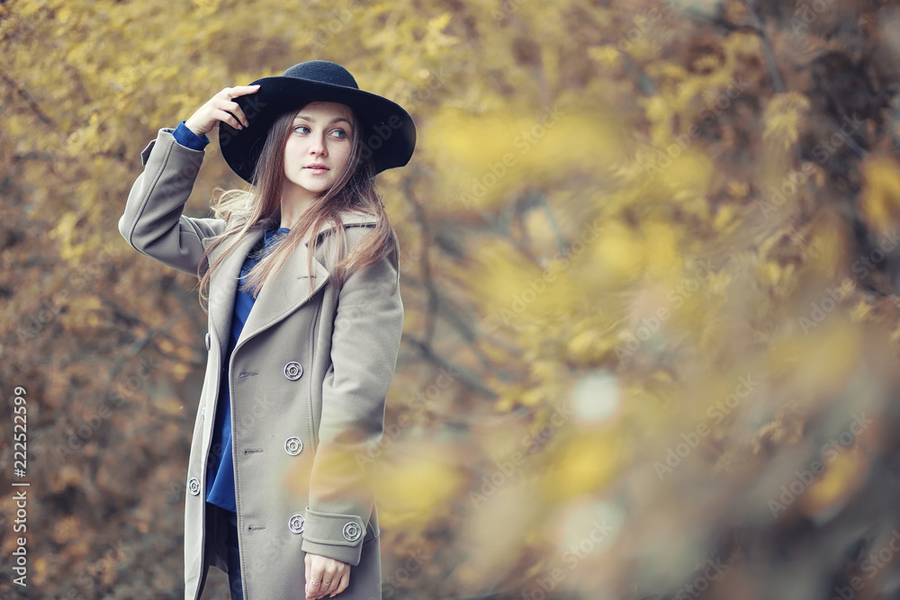 Young girl in a coat in autumn  park