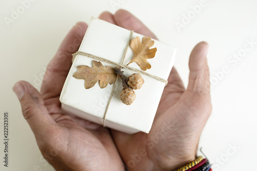 White gift wrapped box decorated with natural accents.