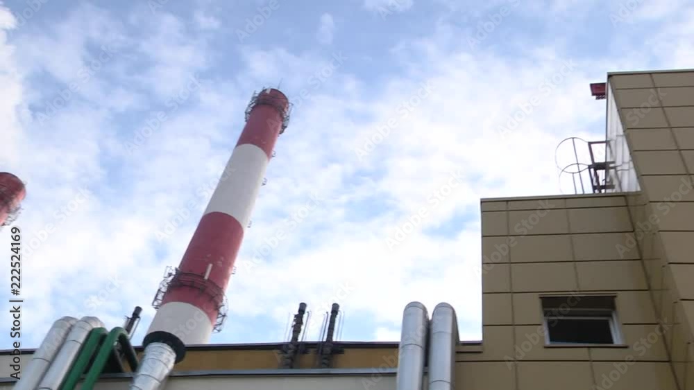 Smoking stack of the thermal power station against a blue sky. Smoking stacks of thermal power station. Smoking stack of the thermal power station against a blue sky. Smoking stacks of thermal power station.