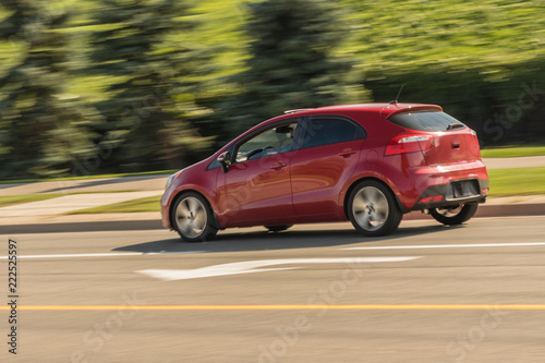 Speeding red mini hatchback