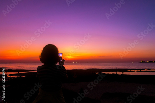 silhouette of woman at sunset