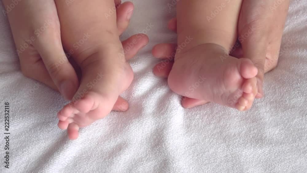 mother playing with her baby feet in slow motion short mother playing with her baby feet in slow motion short