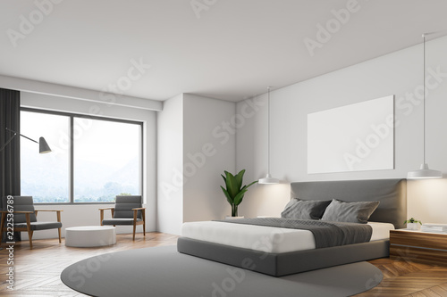 White bedroom, gray bed and poster