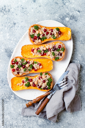 фотографія Stuffed butternut squash with chickpeas, cranberries, quinoa cooked in nutmeg, cloves, cinnamon