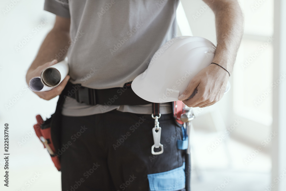 Construction engineer holding safety helmet and projects