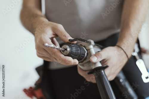 Professional handyman changing a drill bit