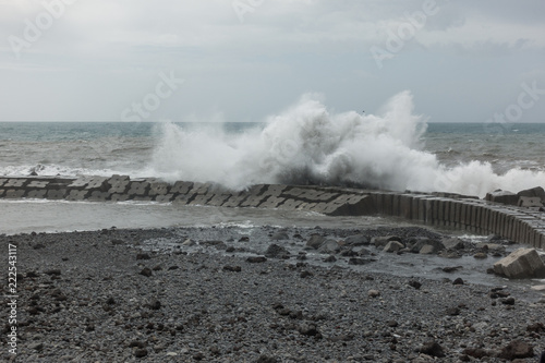 Waves crashing on a pier in Ponta do Sol, Madeira