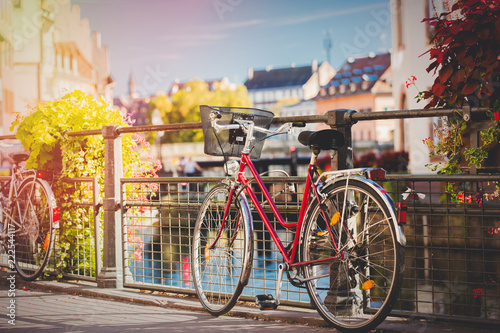 Fototapeta Naklejka Na Ścianę i Meble -  Vintage bike near railing on city street of Strasburg, France. Autumn season time