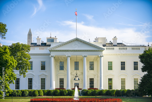 The White House in Washington, D.C. USA on a summer day with clouds forming overhead.