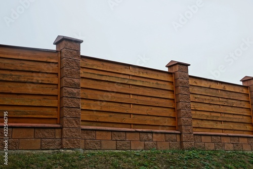 part of a brown private fence in the grass outdoors against the sky