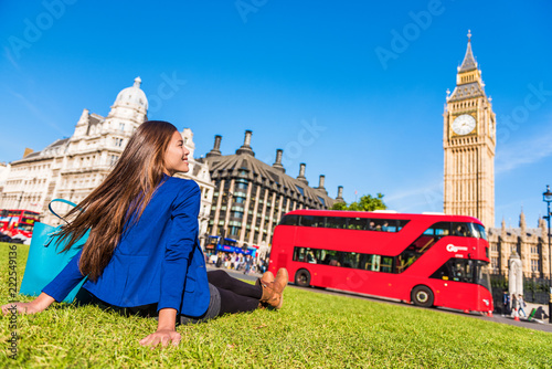 Happy tourist woman relaxing in London city at Westminster Big ben and red bus. Europe destination travel lifestyl.e