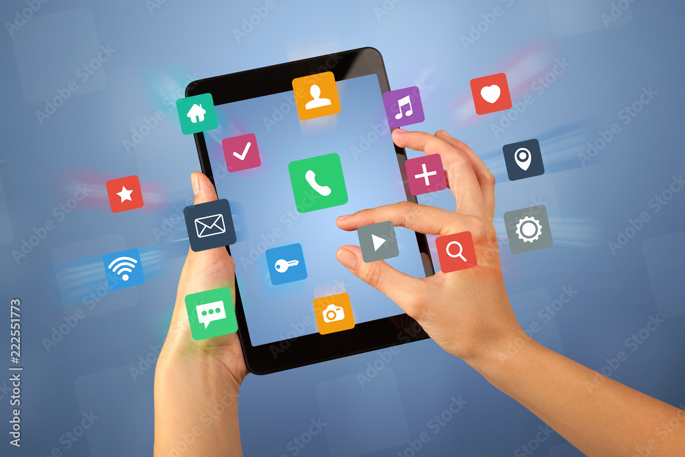 Female fingers touching tablet with colorful applications Female fingers touching tablet with colorful applications