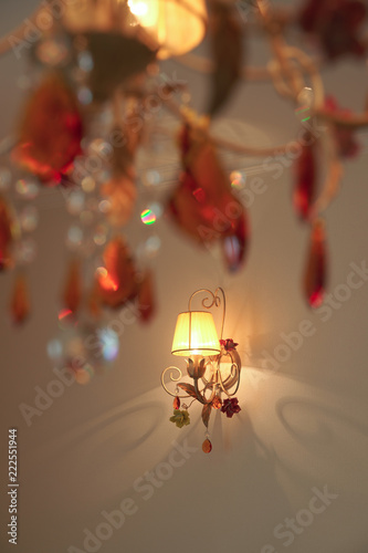 Luminous wall lamp with a soft fabric lampshade shot through glass chandeliers