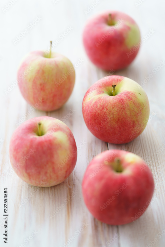 Freshly picked organic light pink apples. White wooden table, high resolution. Freshly picked organic light pink apples. White wooden table, high resolution.