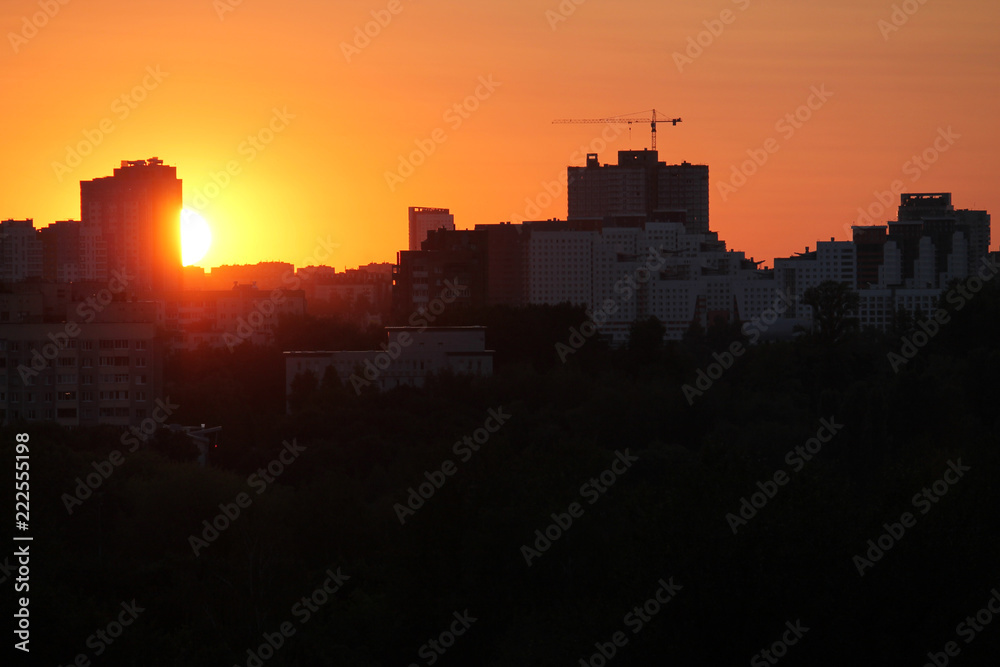 Cityscape with silhouette of city skyline against setting sun. Minsk, Belarus