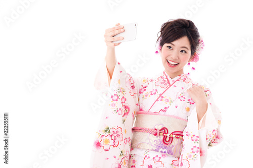 portrait of young asian woman wearing pink kimono on white background