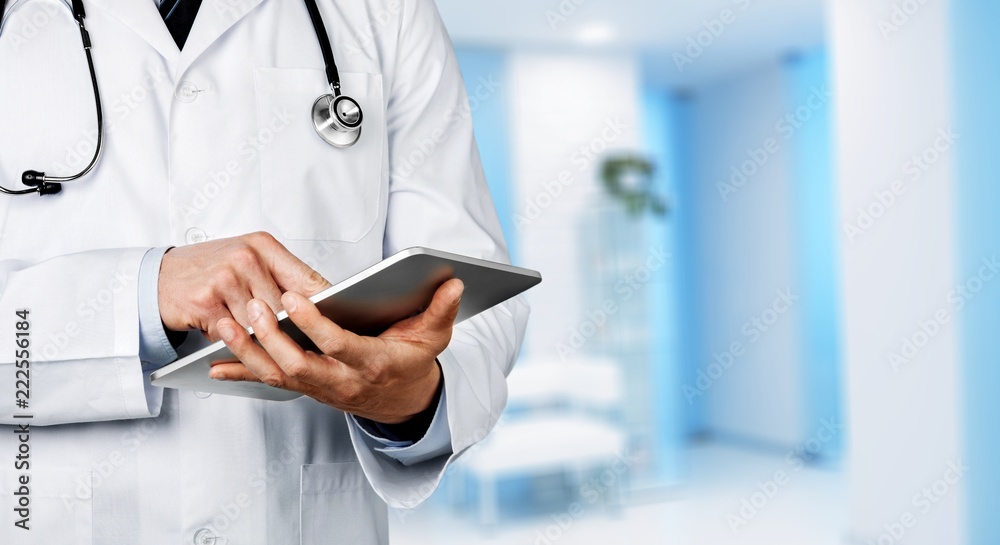 Doctor at hospital working with tablet Doctor at hospital working with tablet