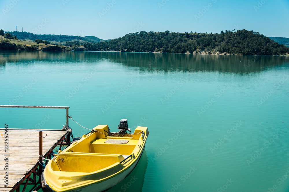 Moored yellow boat. Green Canyon, Manavgat. Rest in Side, Turkey. Pier on the Green Canyon.Travel in warm countries. Boat trip