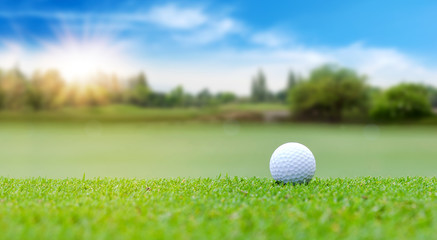 White Golf ball on green course to be shot on blurred beautiful landscape of golf course in bright day time with copy space. Sport, Recreation, Relax in holiday concept