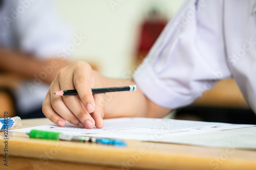 Education art practice concept : Man Hands high school, university student holding pencil for testing drawing and writing paper sheet and exercise in art classroom