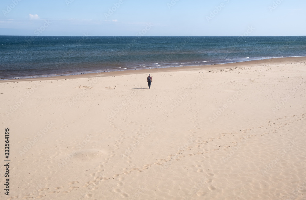 Man Walking Towards the Ocean on Brackley Beach Prince Edward Island Man Walking Towards the Ocean on Brackley Beach Prince Edward Island