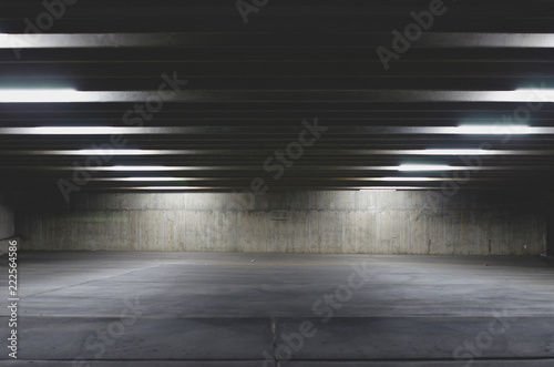 A view of a empty parking lot under the light of the garage on the city night life. 