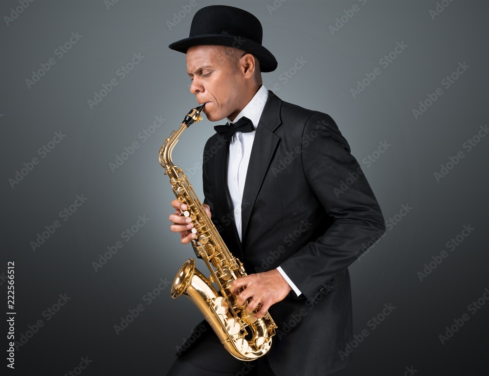 Naklejka premium Close-up man playing on saxophone on white background