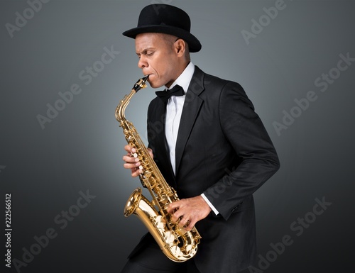 Close-up man playing on saxophone on white background