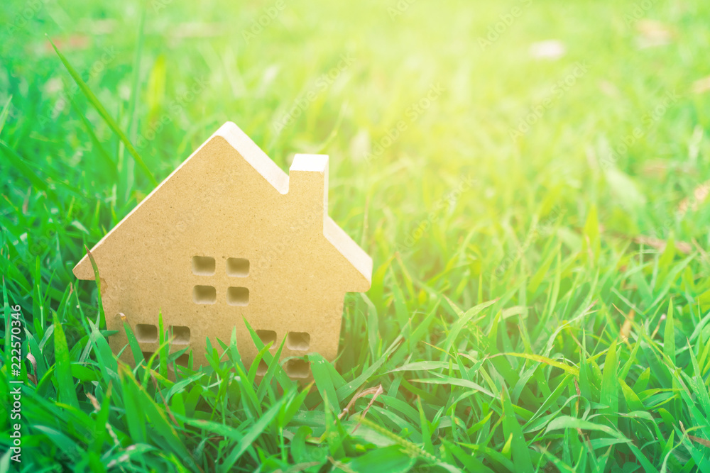 Closed up tiny home model on green grass with sunlight background. Closed up tiny home model on green grass with sunlight background.
