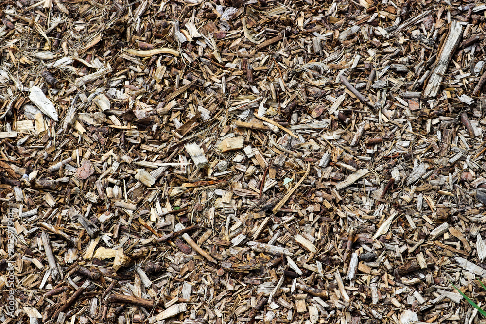 Various brown shades of wooden mulch texture with bark and lumber pieces Various brown shades of wooden mulch texture with bark and lumber pieces