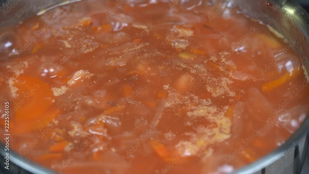 Saucepan with a homemade appetizing and tasty borsch. Red beetroot vegetable soup, boiling in pot. Ukrainian and russian traditional red beet soup - borscht or borsch