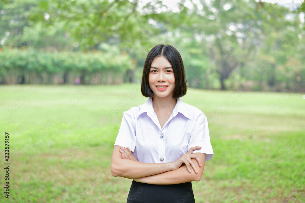 Education Concepts. Beautiful young Asian girl is thinking seriously. Beautiful Asian students are thinking in the garden. Beautiful young students are contemplating what they have learned. Education Concepts. Beautiful young Asian girl is thinking seriously. Beautiful Asian students are thinking in the garden. Beautiful young students are contemplating what they have learned.