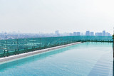 Swimming pool on roof top with beautiful city view at bangkok, thailand.