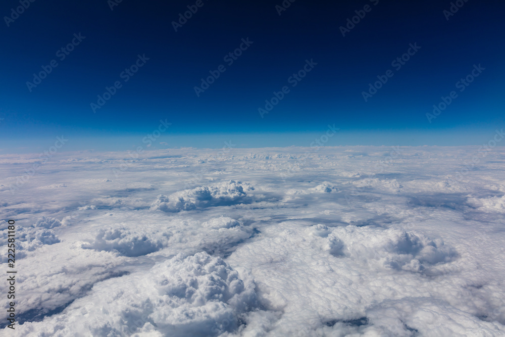 Naklejka premium Cloudscape background. View out of an airplane window.