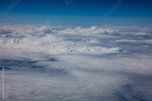 Cloudscape background. View out of an airplane window.