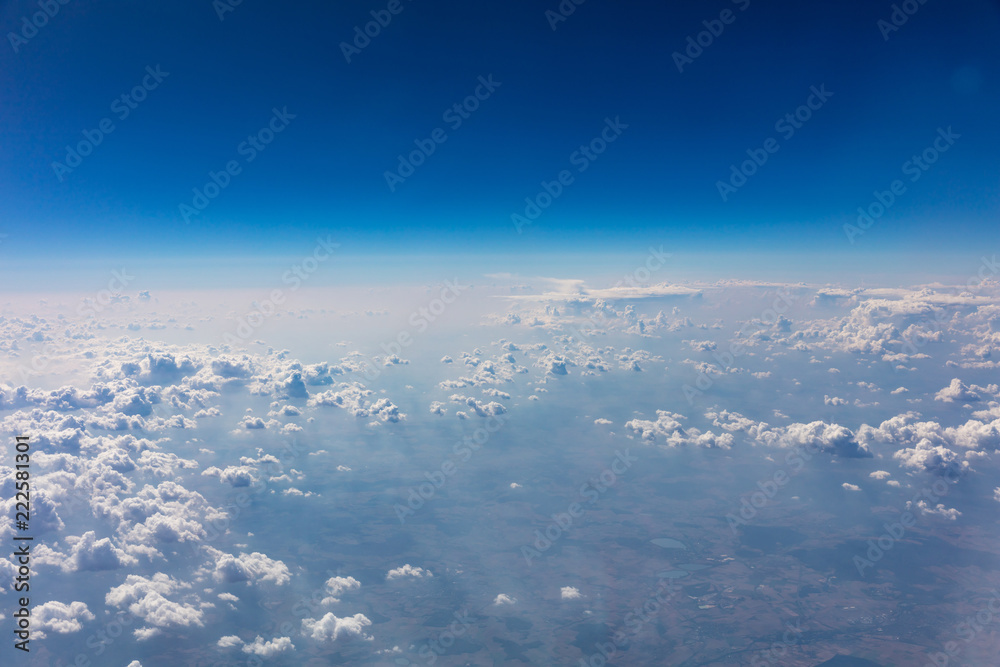 Fototapeta premium Cloudscape background. View out of an airplane window.