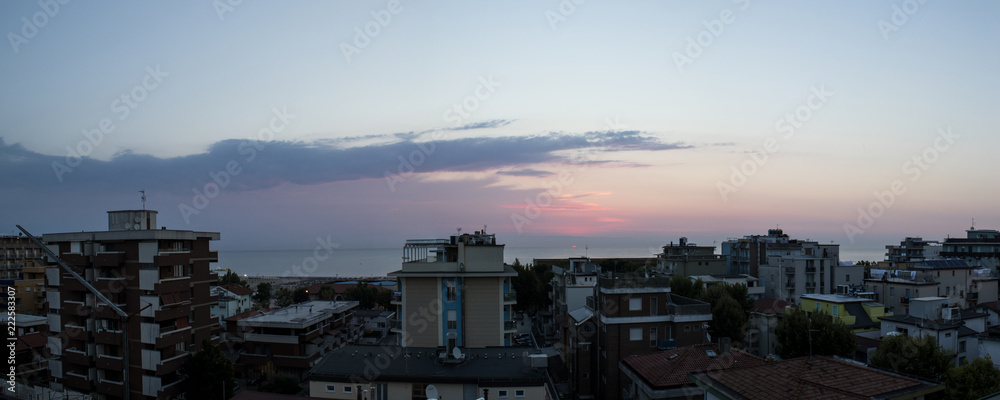 Landscape, sunrise on the sea during summer with buildings
