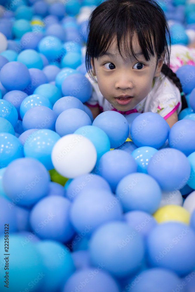 Asian Chinese little girl playing at balls pool Asian Chinese little girl playing at balls pool