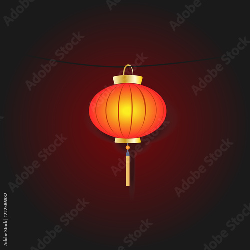 hanging Chinese lantern shines through the darkness