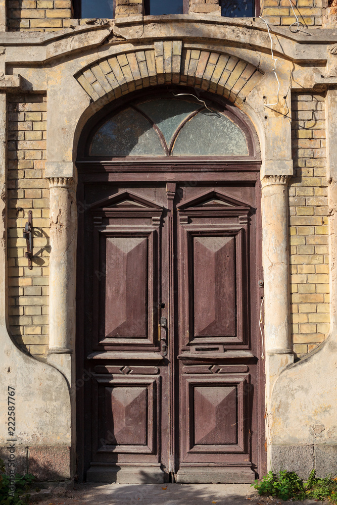 Weathered wooden door in an abandoned buiding Weathered wooden door in an abandoned buiding