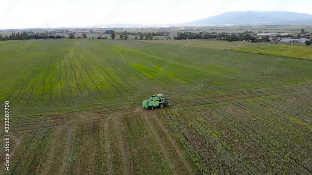 Aerial view of Combine harvester agriculture machine harvesting golden ripe wheat field. Aerial view of Combine harvester agriculture machine harvesting golden ripe wheat field.