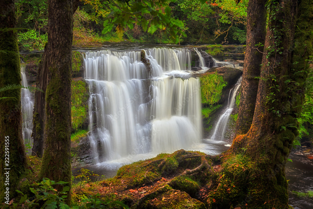 Fototapeta premium Autumn at the waterfall known as Sgwd y Pannwr in Waterfall Country, South Wales, UK 