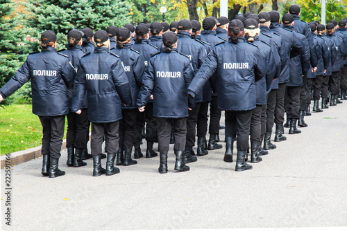 The policemen in uniform with the inscription Police in Ukrainian, stand the street in Dnipro city, Dnepropetrovsk, Ukraine