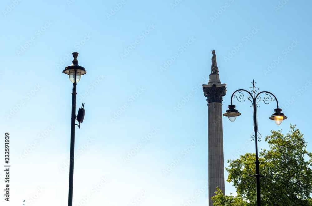 Side view of Nelson's Column and street lights against a summer sky at Trafalgar Square in London, England