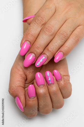 pink moon manicure on long oval nails with triangles, crystals on a white background
