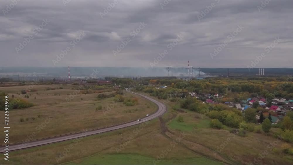 Aerial view of a road to industrial manufacturing plant and warehouses. Logistics and transportation concept Aerial view of a road to industrial manufacturing plant and warehouses. Logistics and transportation concept